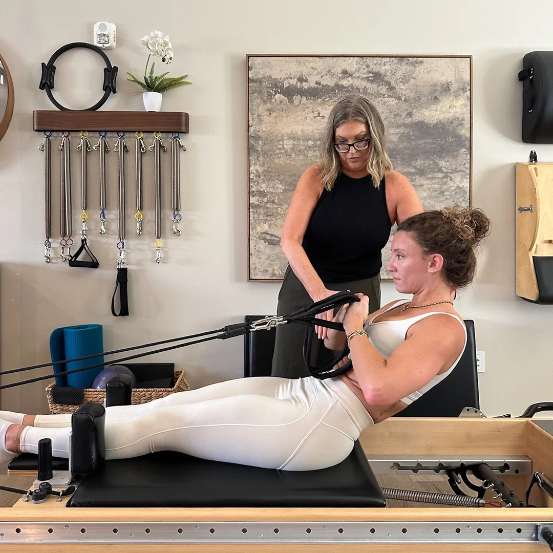 Patti coaching client on the reformer