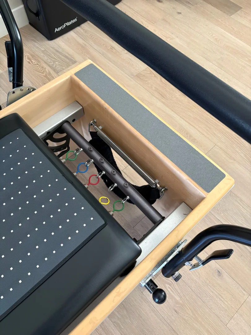Close-up of the Reformer's spring and jump board hardware
