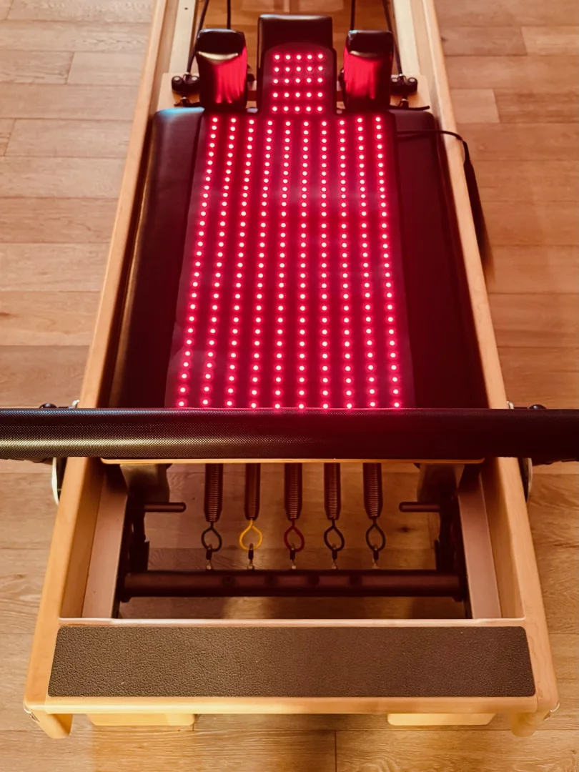 Overhead view of the Reformer fitted with a red light therapy pad